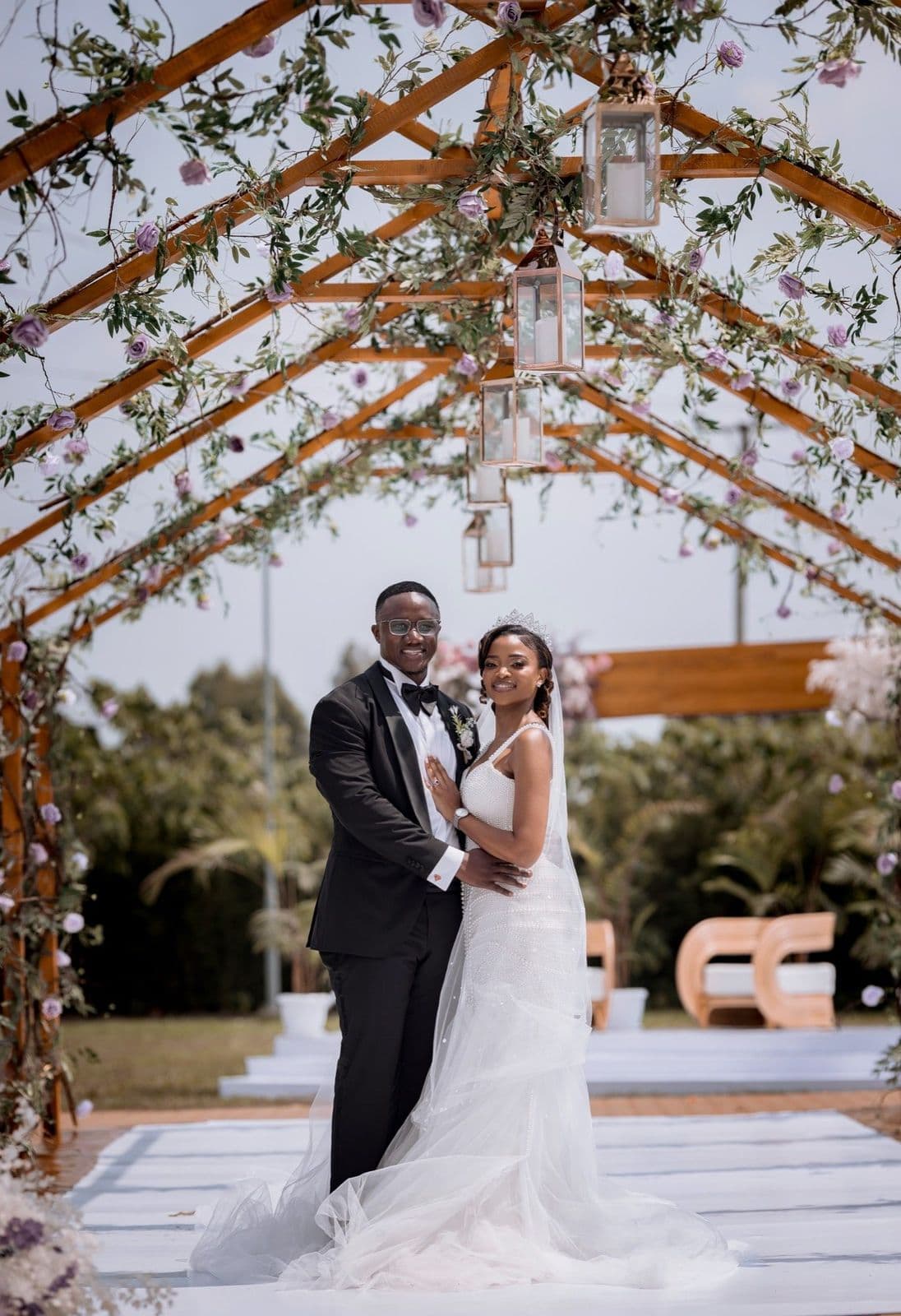 Couple portrait under floral arch styled by Modern Charm Uganda
