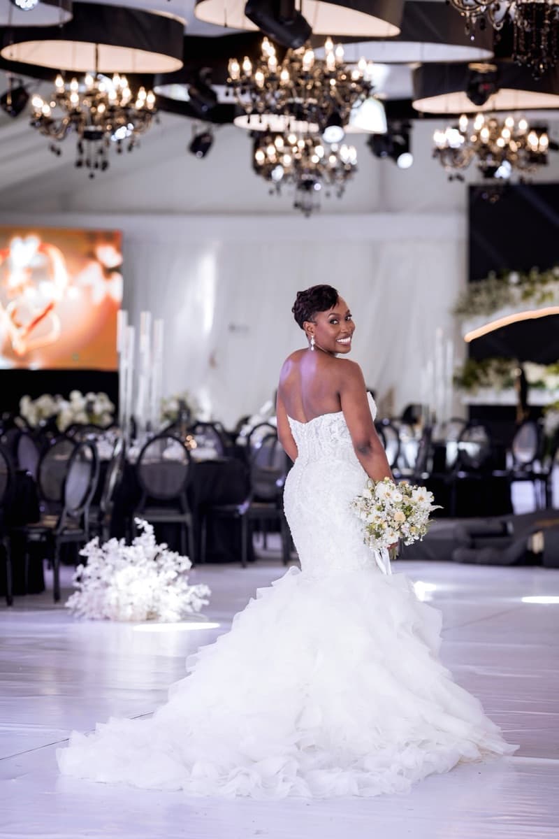 Bride in stunning mermaid gown at a luxury black and gold reception styled by Modern Charm Uganda